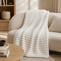 Solid white sculpted fleece throw in a warm neutral living room